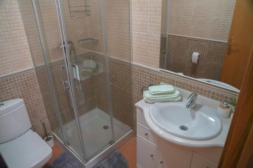 a bathroom with a shower and a sink and a toilet at CASAMONTl in Sanet y Negrals