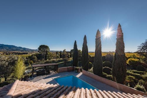 an image of a villa with a swimming pool and trees at Hotel Bellerive in Rasteau