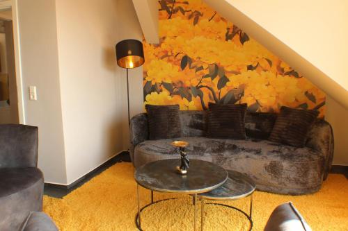 a living room with a couch and a table at Ferienwohnungen Augustinerhof in Quedlinburg