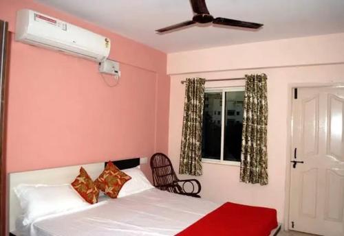 a bedroom with a white bed and a window at Dev Palace in Nawai