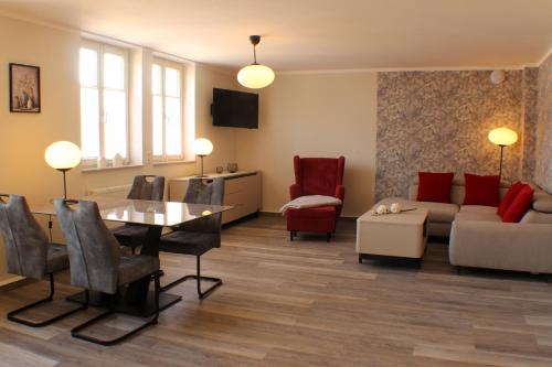 a living room with a couch and a table at Ferienwohnungen Augustinerhof in Quedlinburg