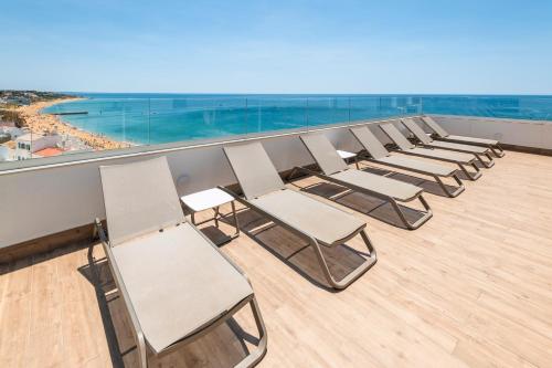 a row of chairs on the roof of a building at Vila Sao Vicente Boutique (Adults Only) in Albufeira