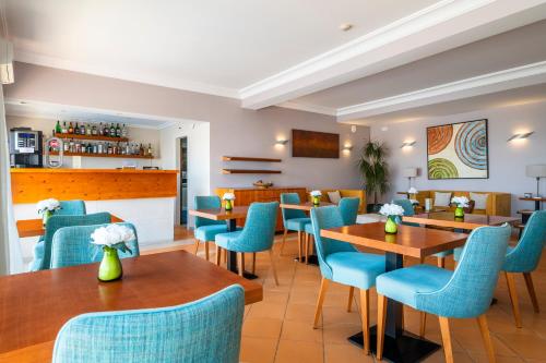 a restaurant with blue chairs and tables at Vila Sao Vicente Boutique (Adults Only) in Albufeira