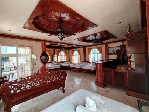 a large room with a bed and a large ceiling at Amerie Rae Resort in Bangui