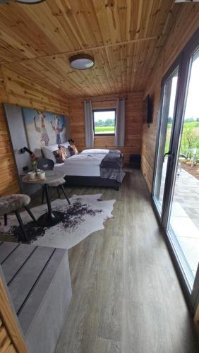 a bedroom with a bed and a large window at Ehringer Hof in Polling