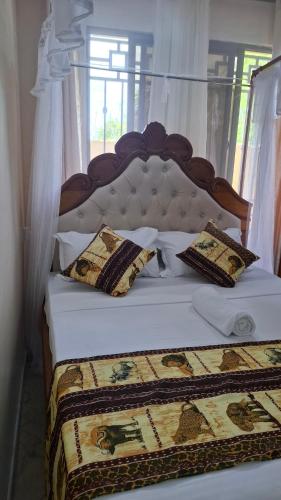 a bedroom with two beds with pillows on them at Westwood Homes in Kilifi