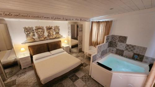 a bedroom with a bed and a bath tub at B&B Triskèles in Giardini Naxos