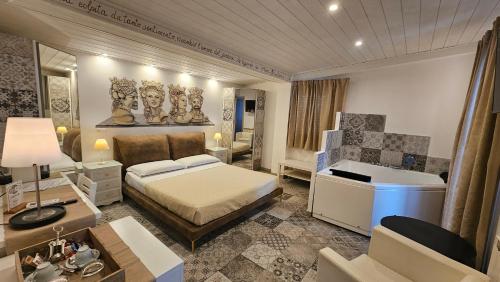 a bedroom with a bed and a desk and a sink at B&B Triskèles in Giardini Naxos