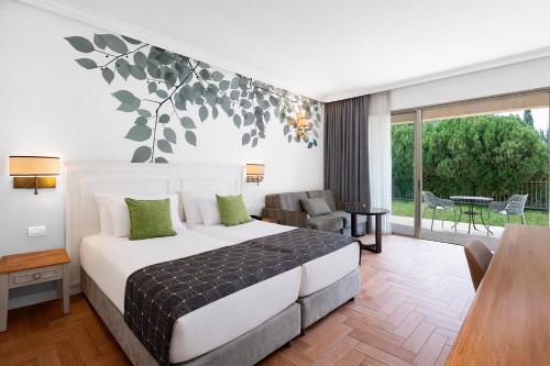a bedroom with a bed and a living room at Lavi Kibbutz Hotel in Lavi