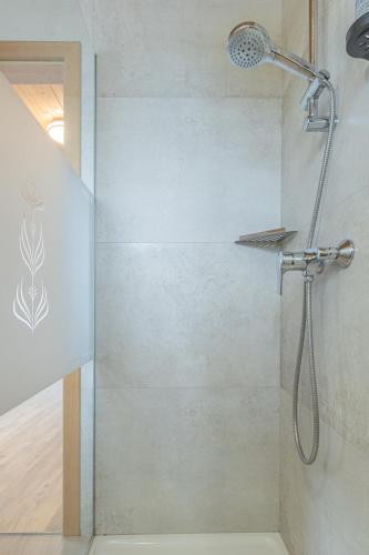 a shower with a shower head in a bathroom at Tourist farm Mulej in Bled