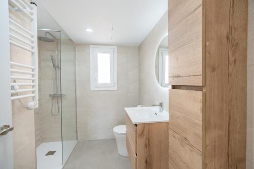 a bathroom with a toilet and a sink and a shower at Casa Ingravita - Oceanfront Tranquility in Cunit