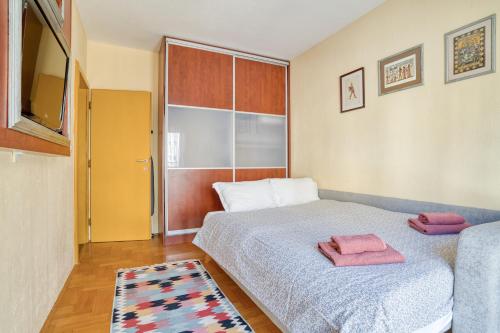 a bedroom with a bed with two towels on it at World Traveler Nest in Kotor