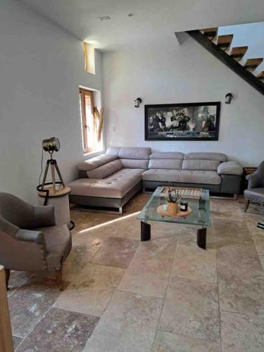 a living room with a couch and a table at L'Echo de la Nature in Sasseville