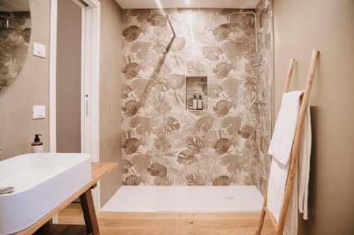a bathroom with a shower and a white sink at Ca' Perenzin in Tarzo