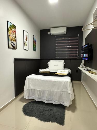a bedroom with a bed with a rug on the floor at Flat JK 102 in Juazeiro do Norte