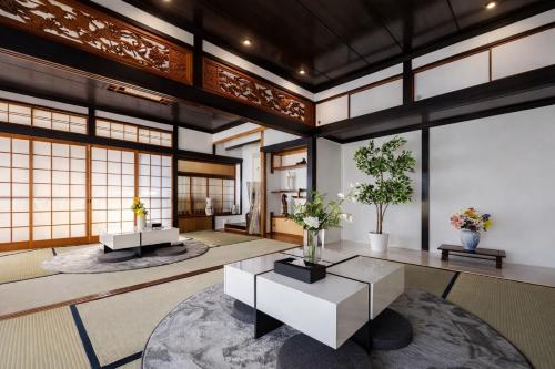a living room with a table and some plants at Nagasaki Night View Terrace Entire Home -Inasayama Panorama稲佐山夜景テラス in Nagasaki