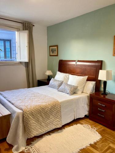 a bedroom with a large bed and a window at Casco antiguo en Ribadesella in Ribadesella