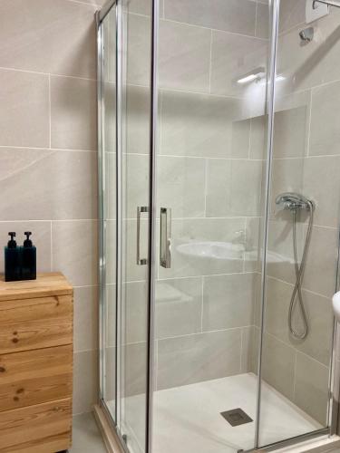 a shower with a glass door in a bathroom at Casco antiguo en Ribadesella in Ribadesella