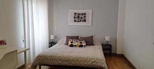 a bedroom with a bed with two pillows on it at Vieira's House Suíte in Barreiro