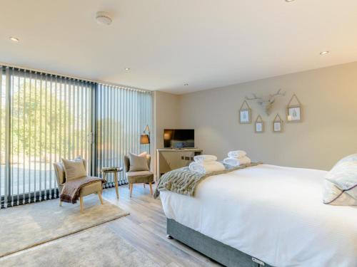 a bedroom with a large bed and a large window at 3 Bed in Belford oc-78057 in Ellington