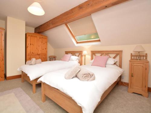 a bedroom with two beds and a skylight at 2 Bed in Matlock oc-75893 in Smalley