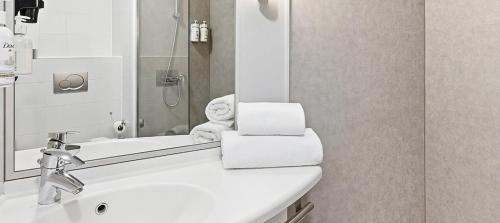 a bathroom with a sink and a mirror at B&B HOTEL Barcelona Mataro in Mataró