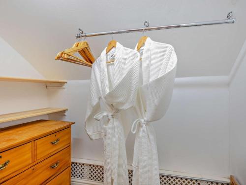 a kitchen with white curtains hanging on a rack at 2 Bed in Bromyard oc-27478 in Pencombe