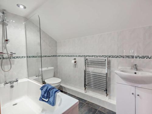 a white bathroom with a sink and a toilet at 3 Bed in Ellesmere oc-94419 in Dodleston