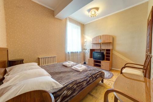 Cama o camas de una habitación en Aleksandria Hotel
