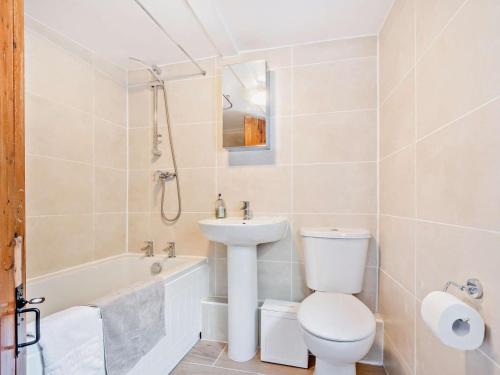 a white bathroom with a toilet and a sink at 2 Bed in Swindon oc-93489 in Bishopstone