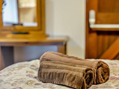 a brown towel sitting on top of a bed at 2 Bed in Ellesmere oc-94418 in Dodleston