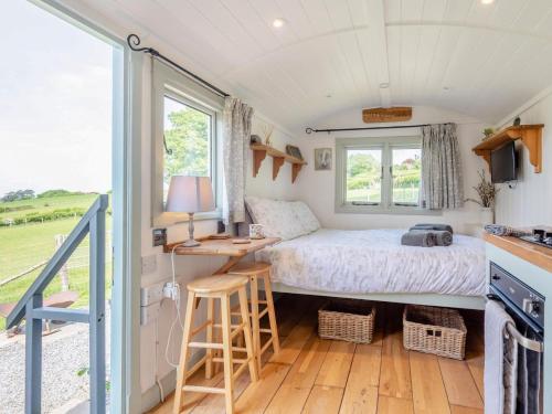 a small bedroom with a bed and a desk at 1 Bed in Hereford oc-79575 in Byford