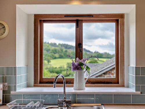 a kitchen sink with a window with a train view at 1 Bed in Bucknell oc-94661 in Letton