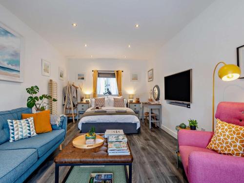 a living room with a bed and a couch and a table at 1 Bed in Kidderminster oc-94769 in Orleton