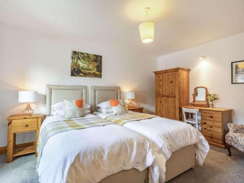 a bedroom with a large bed and a chair at 1 Bed in Ludlow oc-chl23 in Orleton