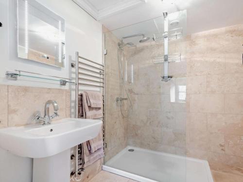 a white bathroom with a sink and a shower at 1 Bed in Frome oc-91715 in Woolverton