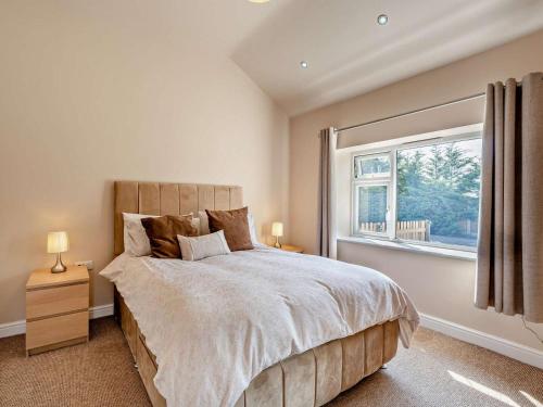 a bedroom with a large bed and a window at 2 Bed in Blakeney oc-54765 in Awre