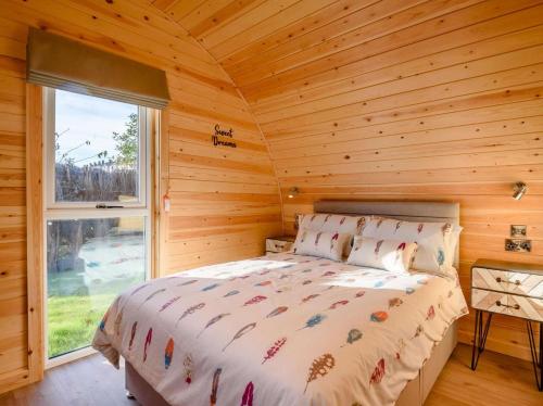 a bedroom with a bed in a log cabin at 1 Bed in Alfreton oc-90518 in South Wingfield