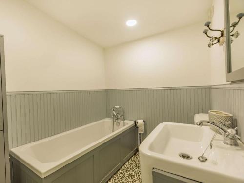 a white bathroom with a tub and a sink at 1 Bed in Hereford oc-87736 in Moccas