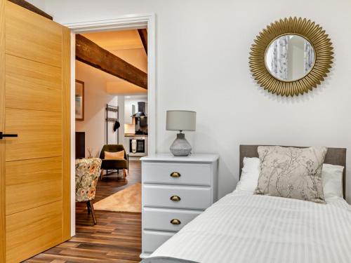 a bedroom with a white bed and a mirror at 2 Bed in High Peak oc-94058 in New Mills