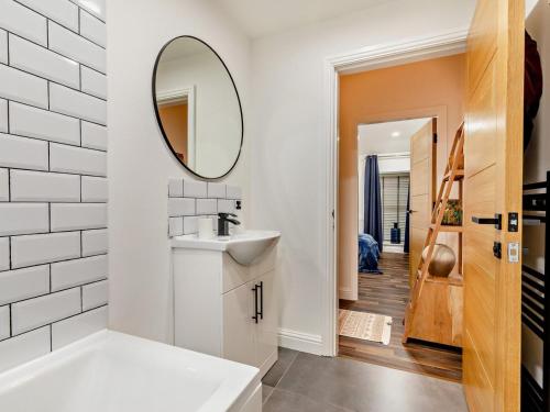 a white bathroom with a sink and a mirror at 2 Bed in High Peak oc-94058 in New Mills
