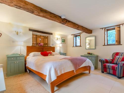 a bedroom with a large bed and a chair at 2 Bed in Kidderminster oc-cc090 in Bayton