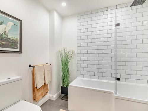 a white bathroom with a tub and a shower at 2 Bed in High Peak oc-94059 in New Mills