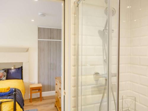 a bathroom with a shower and a bedroom with a bed at 2 Bed in Ilkley oc-89554 in Ilkley
