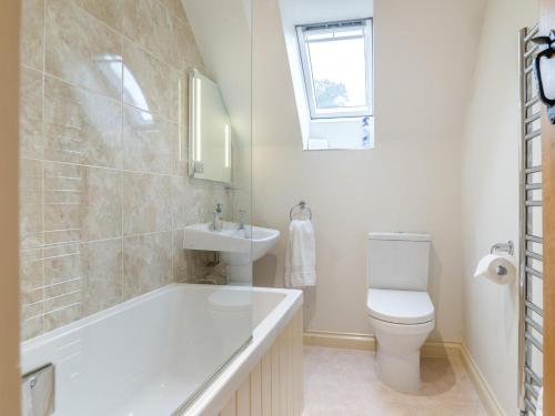 a bathroom with a tub and a toilet and a sink at 2 Bed in Bristol oc-72582 in Winford
