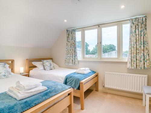 a bedroom with two beds and a window at 2 Bed in Bristol oc-72582 in Winford
