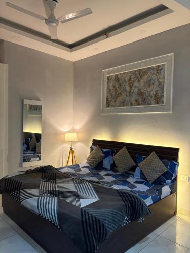 a bedroom with a large bed with blue and white at The dream studio in Noida