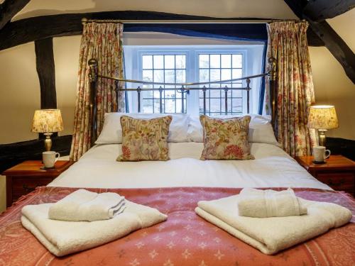 a bedroom with a bed with two pillows on it at 2 Bed in Evesham oc-49245 in Cleeve Prior