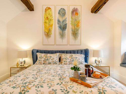 a bedroom with a bed with a tray of food on it at 1 Bed in Hope Valley oc-89720 in Hope