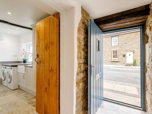 a door leading to a laundry room with a stone wall at 1 Bed in Hope Valley oc-89720 in Hope